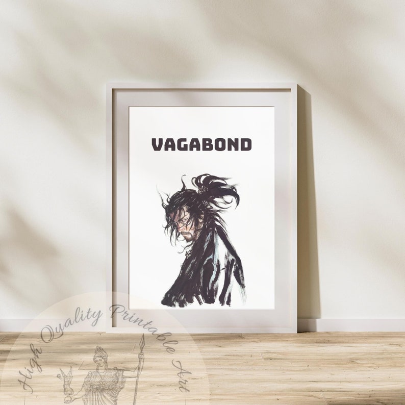 May include: A white framed print with the word "VAGABOND" in black text at the top. The print features a black and white illustration of a man with long hair and a beard, wearing traditional Japanese clothing.