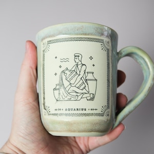 Handmade Ceramic Zodiac Mug – Aquarius Astrology Design with Earthy Green Glaze | Artisan Pottery Coffee Cup