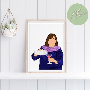 May include: A framed print featuring a person pouring a pink cocktail into a martini glass. The person is wearing a blue top and a purple scarf. A green circle with the text "PDF PATTERN" is in the upper right corner.