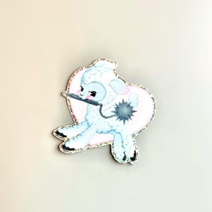 May include: A blue and white cartoon lamb with a pink heart behind it. The lamb is holding a spiked club and has an angry expression.