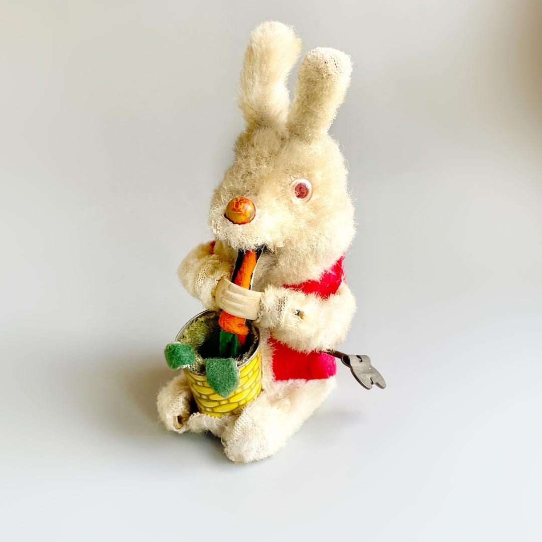 f188- retro metal clockwork toy depicting a rabbit playing drums