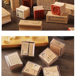 May include: A set of 10 wooden stamps in clear plastic boxes. The stamps feature various designs, including a calendar, a clock, a thermometer, and a hand pointing to the right. The stamps are perfect for adding a personal touch to journals, planners, and other paper crafts.