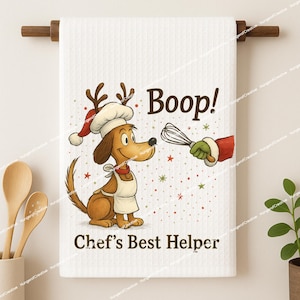 May include: White kitchen towel with a cartoon dog wearing a chef's hat and apron, with the text "Boop!" and "Chef's Best Helper." The dog is holding a whisk, and the design includes red and green accents.