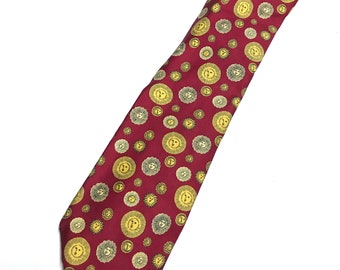 May include: A red silk tie with a repeating pattern of gold sun-like designs.