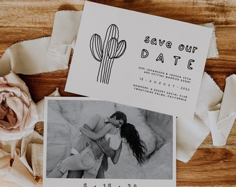 May include: A wedding announcement with a black and white cactus illustration and the words "save our DATE". Below is a black and white photo of a couple. The date is August 18, 2023. The announcement is on a wooden tray with fabric and a rose.