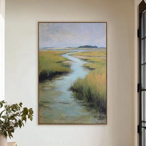May include: A framed landscape painting depicts a marsh scene with a winding waterway. The artwork features a palette of greens, blues, and yellows, with a muted sky. The painting is displayed in a bright hallway, adding a touch of nature to the interior.