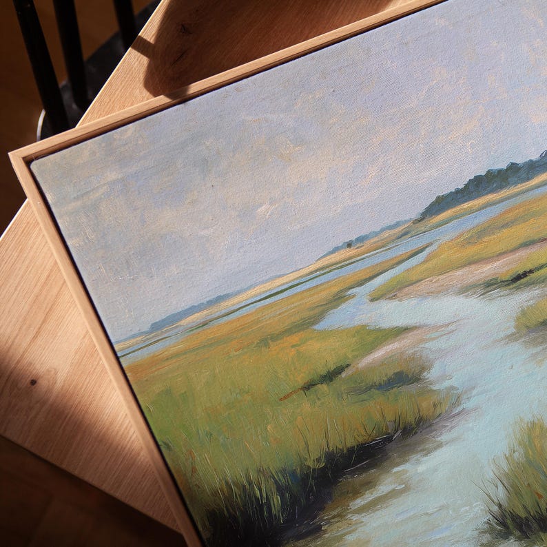 May include: An oil painting of a marsh landscape with a light blue sky. The artwork features a palette of greens, yellows, and blues, with a wooden frame. The painting depicts a serene scene of water and grassy areas.