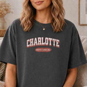 Dark grey t-shirt with "CHARLOTTE NORTH CAROLINA" text across the chest.