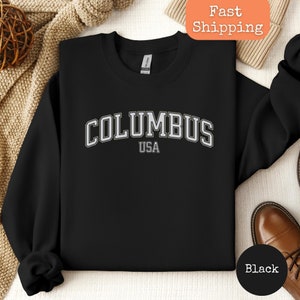 May include: Black sweatshirt with white text that reads "COLUMBUS USA".