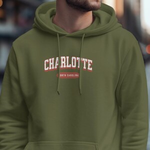 Green hoodie with "Charlotte, North Carolina" text.