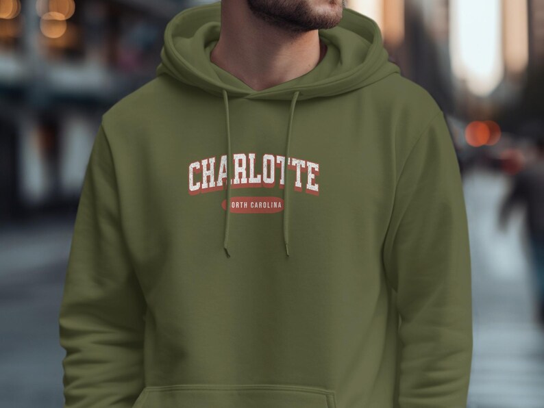 Green hoodie with "Charlotte, North Carolina" text.