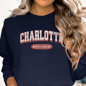 Navy sweatshirt with "Charlotte North Carolina" in distressed white lettering.