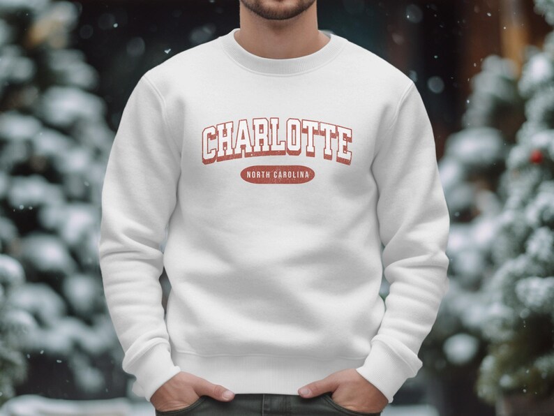 White sweatshirt with "Charlotte North Carolina" text.