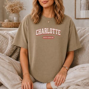 T-shirt with "Charlotte North Carolina" text in collegiate style lettering.