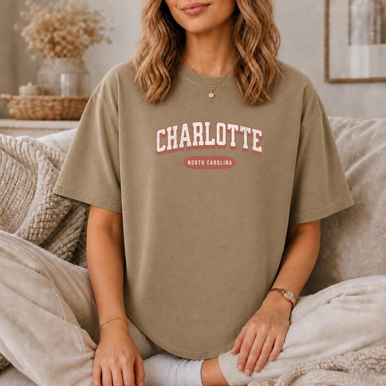 T-shirt with "Charlotte North Carolina" text in collegiate style lettering.