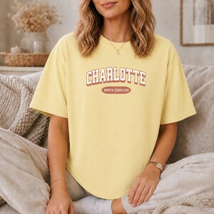 Yellow t-shirt with "Charlotte North Carolina" text.