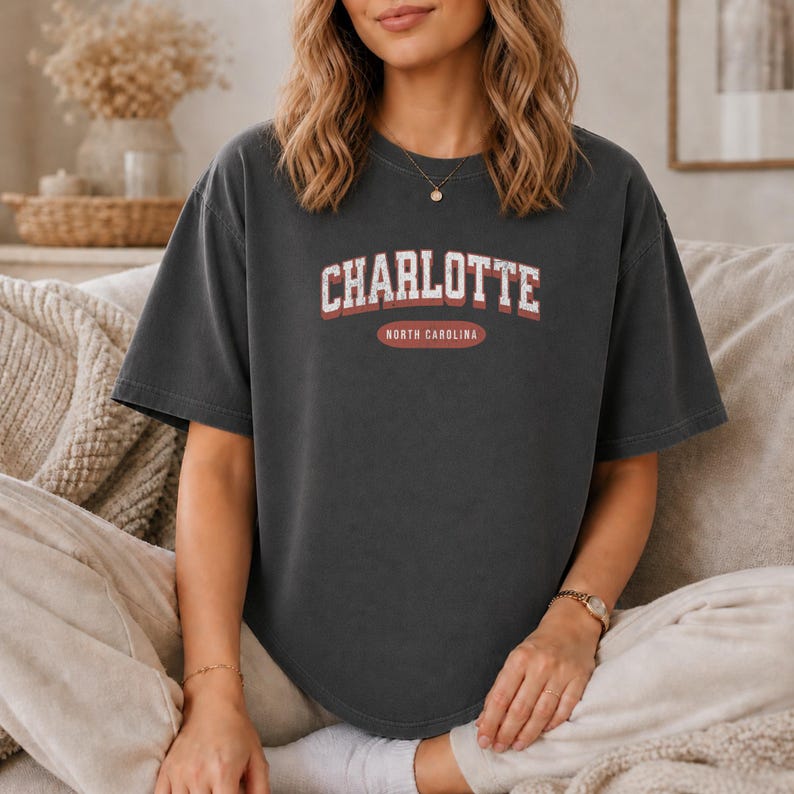 Dark grey t-shirt with "CHARLOTTE NORTH CAROLINA" text across the chest.