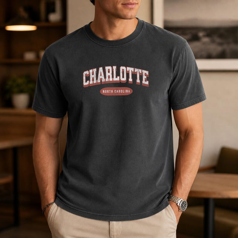 Charcoal t-shirt with "Charlotte North Carolina" text in red and white.