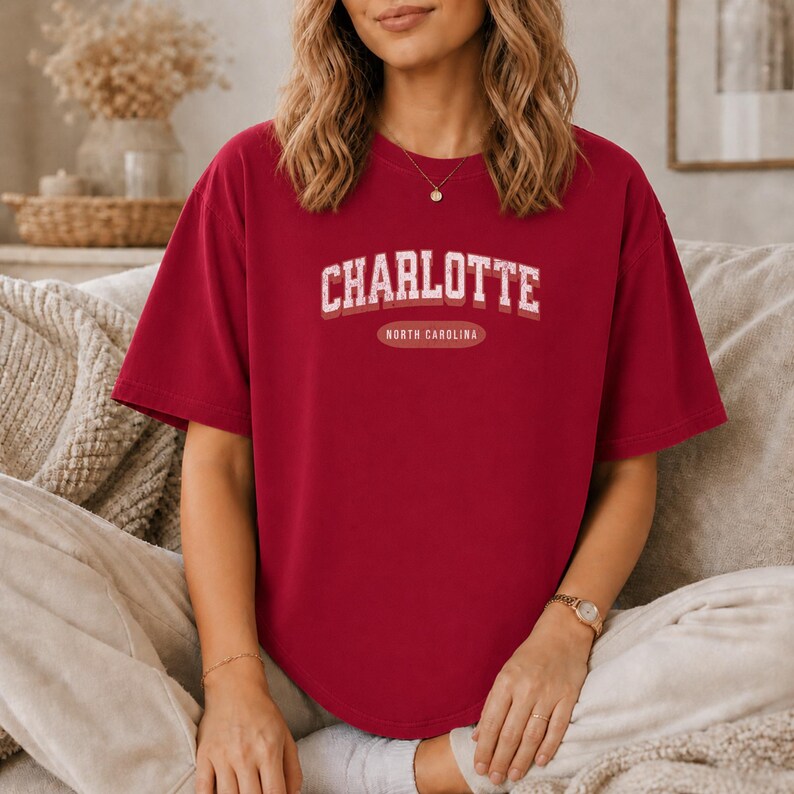 Dark red t-shirt with "Charlotte North Carolina" graphic detail.