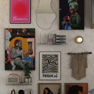 May include: A wall gallery featuring a variety of framed artwork, including abstract prints, a collage with a woman in a floral dress, and a framed quote from Colossians 3:14. The gallery also includes a wooden wall hanging, a small mirror, and a shelf with books and candles.