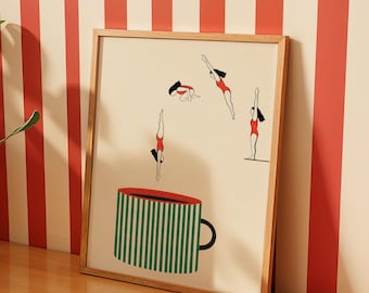 May include: A framed art print featuring a large green and white striped coffee mug at the bottom. Above the mug, three figures in red swimsuits are depicted in various diving positions, with one figure standing on the edge of the mug rim.