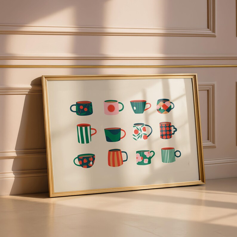 May include: A framed art print featuring a collection of twelve colorful mugs with various patterns. The mugs are in shades of red, green, and blue, with designs including polka dots, stripes, and floral motifs. The frame is gold.