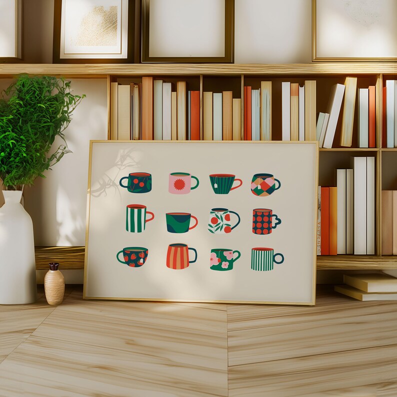 May include: A framed print featuring a collection of colorful, patterned mugs. The mugs are in various designs, including stripes, polka dots, and floral patterns. The print is displayed on a wooden surface, with a bookshelf in the background.