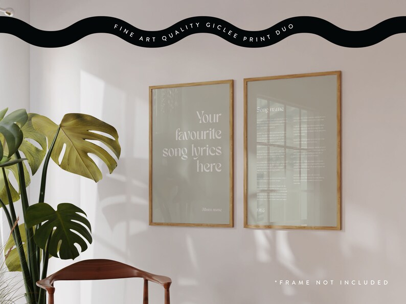 May include: A gicl&eacute;e print duo featuring two framed artworks. One displays the text "Your favourite song lyrics here", the other contains song lyrics. Both are in light-colored frames, with a plant and chair in the foreground.