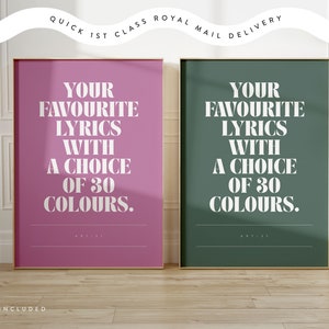 May include: Two framed art prints with gold trim. One print is a vibrant pink, the other is a deep green. Both feature the text "YOUR FAVOURITE LYRICS WITH A CHOICE OF 30 COLOURS." The top of the image reads "QUICK 1ST CLASS ROYAL MAIL DELIVERY."