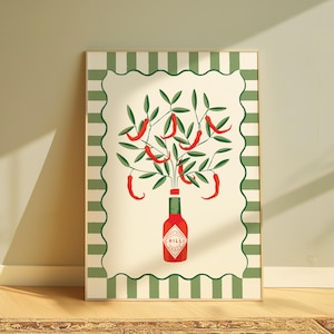 May include: A framed art print featuring a stylized illustration of a red chili pepper plant. The plant emerges from a red bottle with the word "CHILLI" on it. The artwork is framed with a green and white striped border.