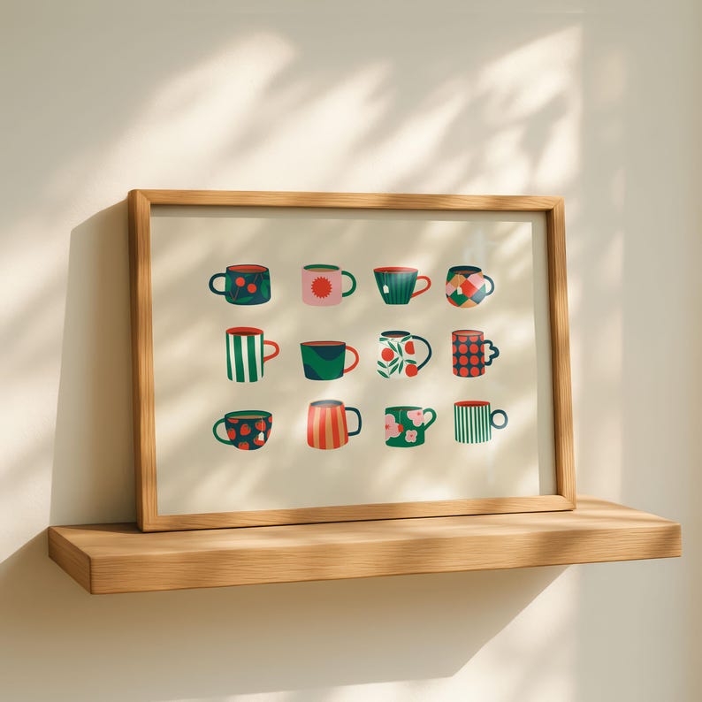 May include: A framed print featuring a collection of twelve colorful mugs with various patterns. The mugs are in shades of red, green, pink, and blue, with designs including stripes, dots, and floral motifs. The print is displayed on a wooden shelf.