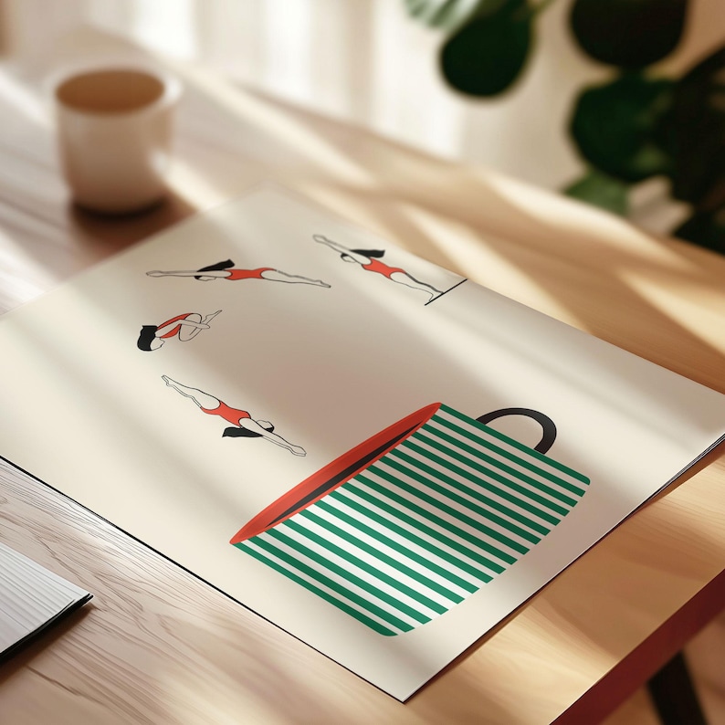 May include: An art print featuring illustrations of swimmers in red swimsuits, with a large green and white striped coffee cup design. The print is on a cream-colored background, with a cup and a mug in the background.