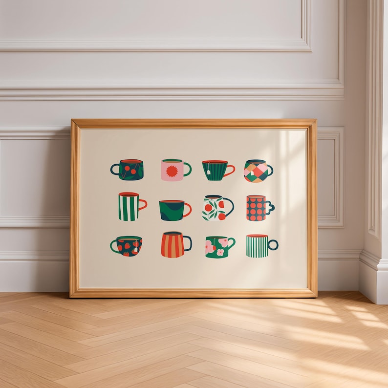 May include: A framed print featuring twelve colorful mugs with various patterns. The mugs are arranged in three rows of four, each with a unique design, including polka dots, stripes, and floral motifs. The frame is a light wood color, and the background is a neutral beige.