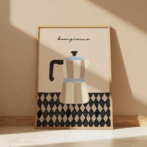 May include: A framed art print featuring a stylized illustration of a coffee maker in beige, light blue, and black. The word "buongiorno" is written in cursive at the top. The bottom of the print has a black and white diamond pattern.