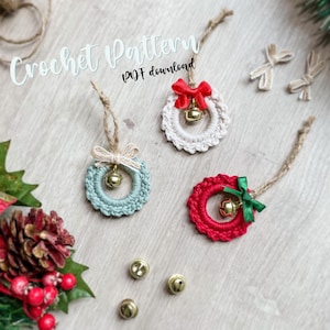 May include: Three crocheted Christmas wreaths with bells and ribbon accents. The wreaths are in red, white, and green. Crochet pattern PDF download.