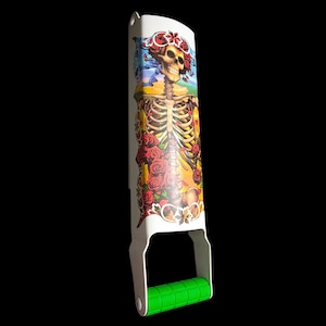 May include: White metal bottle opener with a colorful graphic of a skeleton with roses and a skull. The handle is green.