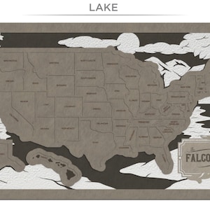 Puede incluir: Una obra de arte de papel recortado marr&oacute;n que representa un mapa de los Estados Unidos con el texto "LAKE" en la parte superior y "THE FALCONES" en la parte inferior.