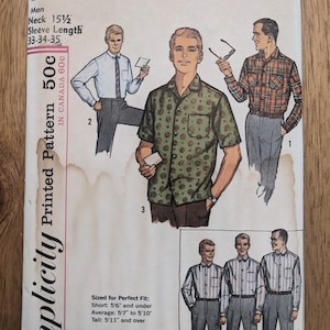 Könnte beinhalten: Ein Vintage-Schnittmuster von Simplicity für Herrenhemden. Die Schnittmuster-Nummer lautet 5029 und das Schnittmuster ist für einen Halsumfang von 15 1/2 Zoll und eine Ärmellänge von 33-34-35 Zoll. Das Schnittmuster enthält Anleitungen zum Nähen von drei verschiedenen Hemdenstilen, darunter ein kurzärmeliges Hemd mit Knöpfen und einem Blumendruck, ein langärmeliges Hemd mit Knöpfen und einem Karomuster und ein kurzärmeliges Hemd mit Knöpfen und einem Streifendesign.