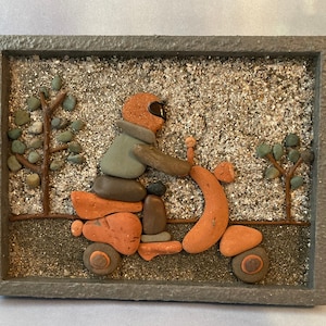 Man on motorcycle Vespa Pebble art.