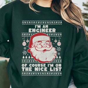 May include: Green Christmas sweater with a Santa Claus graphic and the text "I'm an Engineer, of course I'm on the nice list."