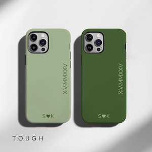 May include: Two phone cases, one in a muted green and the other in a darker green. Each case has the Roman numeral XV-MMXXV and the initials S♥K printed on it. The word "TOUGH" is printed at the bottom.