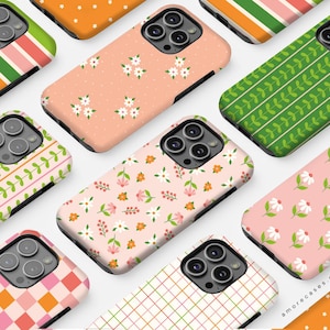 May include: A collection of phone cases with various floral and geometric patterns. The cases feature designs with white flowers, green leaves, and pink and orange geometric shapes. The cases are in a variety of colors, including pink, orange, and green.
