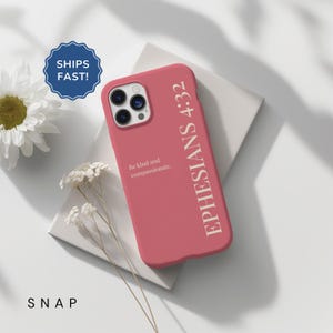 May include: A coral-colored phone case with the text "EPHESIANS 4:32" and "Be kind and compassionate." A blue and white sticker that says "SHIPS FAST!" is in the upper left corner. The word "SNAP" is at the bottom.