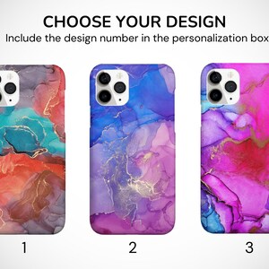 May include: Three iPhone cases with abstract designs featuring swirling colors of blue, pink, purple, and red with gold accents. The designs are numbered 1, 2, and 3.