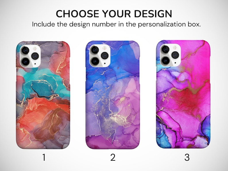 May include: Three iPhone cases with abstract designs featuring swirling colors of blue, pink, purple, and red with gold accents. The designs are numbered 1, 2, and 3.