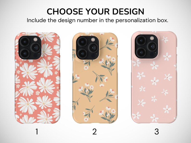 May include: Three phone cases with different floral patterns. The first case has a pink background with large white flowers. The second case has a light orange background with smaller white flowers and green stems. The third case has a light pink background with small white flowers.
