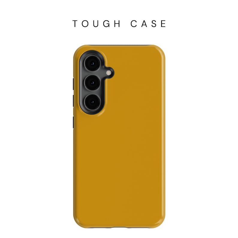 May include: Mustard yellow phone case with a triple-lens camera cutout. The case has a smooth finish and the text "TOUGH CASE" is printed at the top. The phone case is designed to protect the phone.