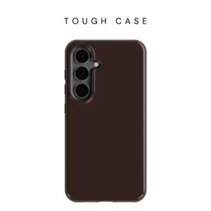 May include: A dark brown phone case with a camera lens cutout. The case is designed to protect a phone from damage.