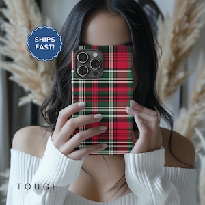 May include: A red, green, and white plaid phone case for an iPhone 13 Pro Max. The case is made of a tough, durable material and has a sleek, modern design.