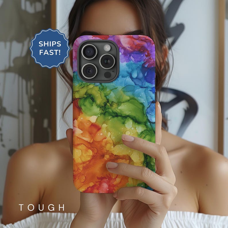 May include: A colorful phone case with a rainbow abstract design. The case has a camera cutout and is made of durable material.